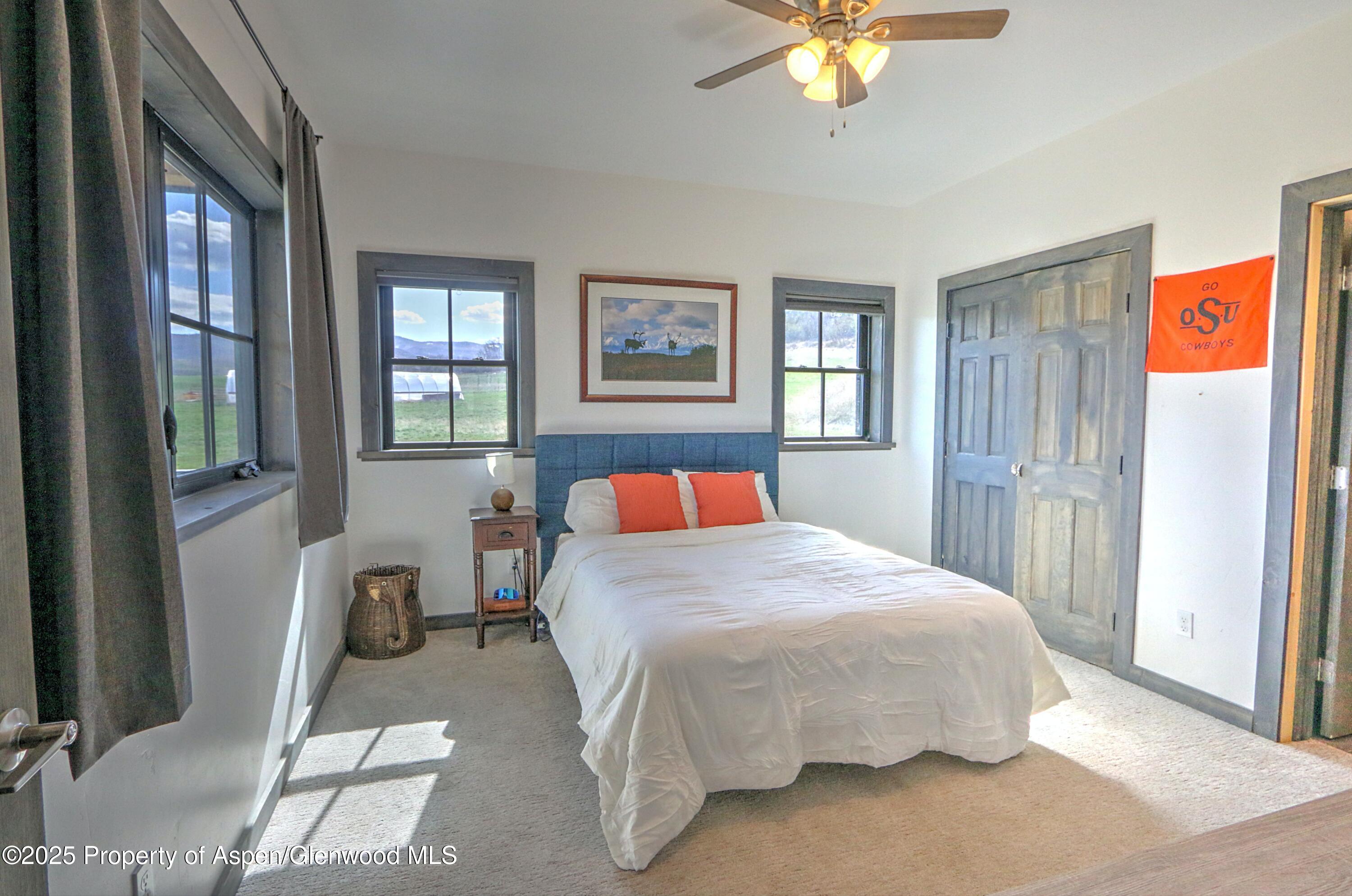 7315 County Road 312 New Castle, CO 81647 - Photo 21 of 75 a bedroom with a bed and a chandelier