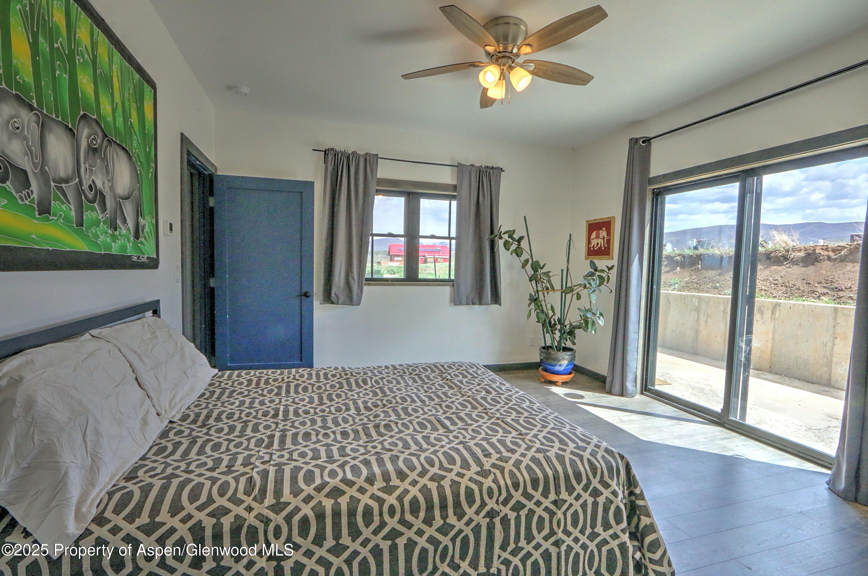 7315 County Road 312 New Castle, CO 81647 - Photo 34 of 75 a bedroom with a bed and a chandelier