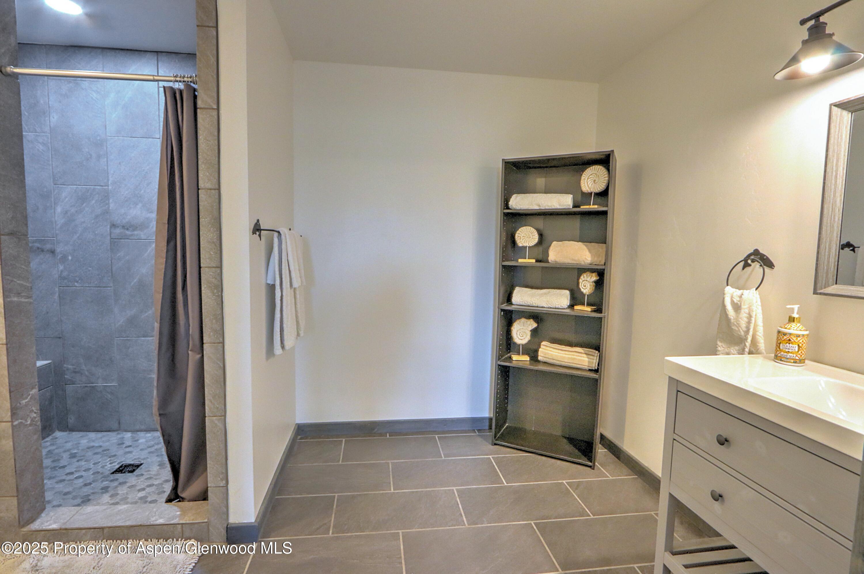 7315 County Road 312 New Castle, CO 81647 - Photo 36 of 75 a bathroom with a double vanity sink and a mirror