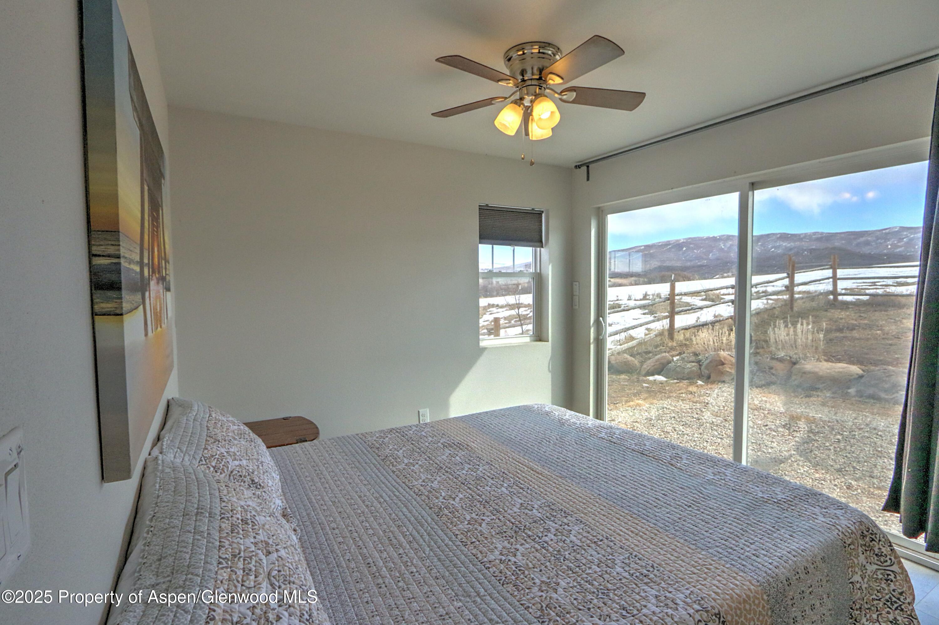 7315 County Road 312 New Castle, CO 81647 - Photo 51 of 75 a bedroom with a bed and a chandelier