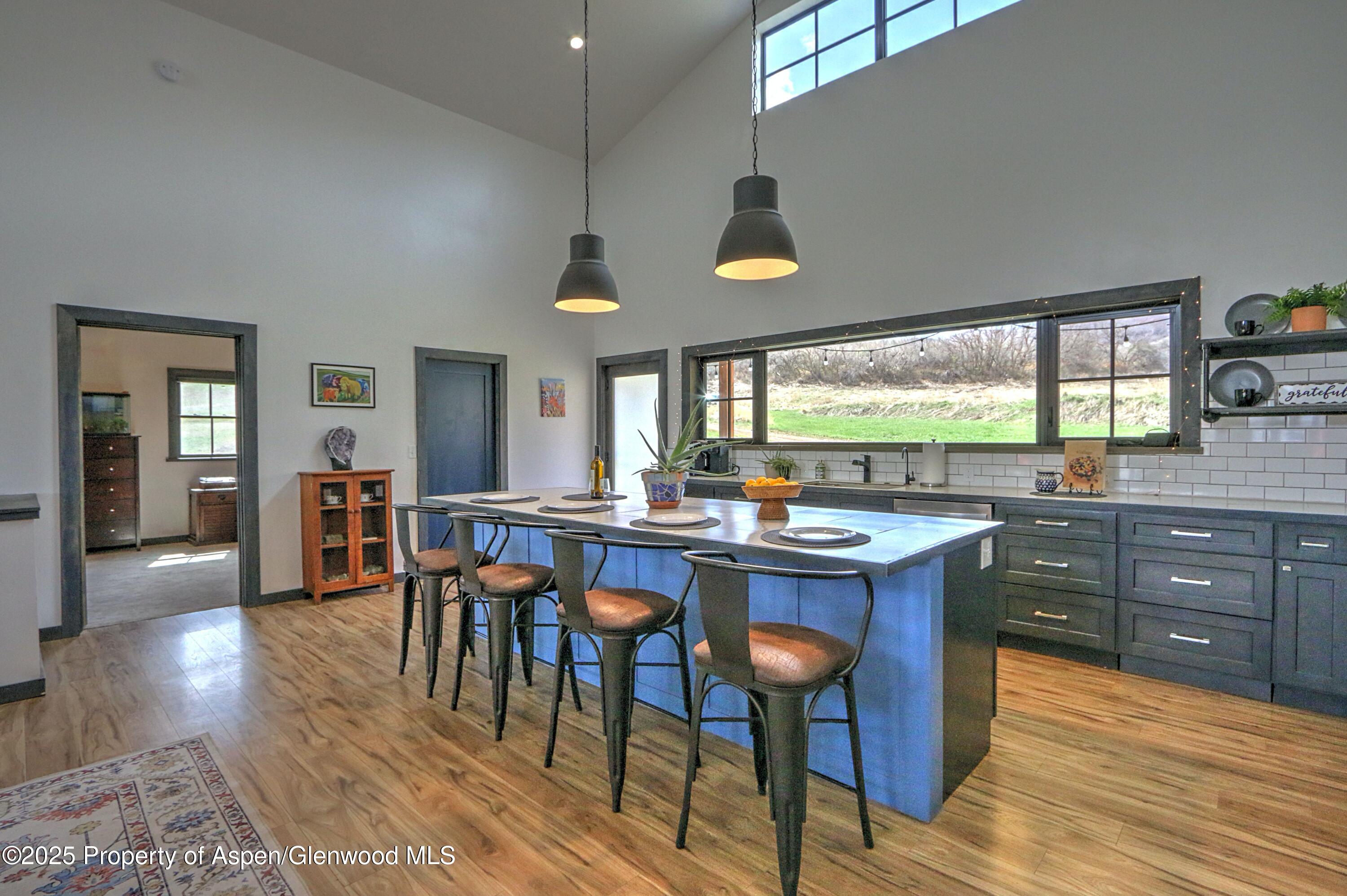 7315 County Road 312 New Castle, CO 81647 - Photo 9 of 75 a kitchen with lots of counter space and painting on the wall