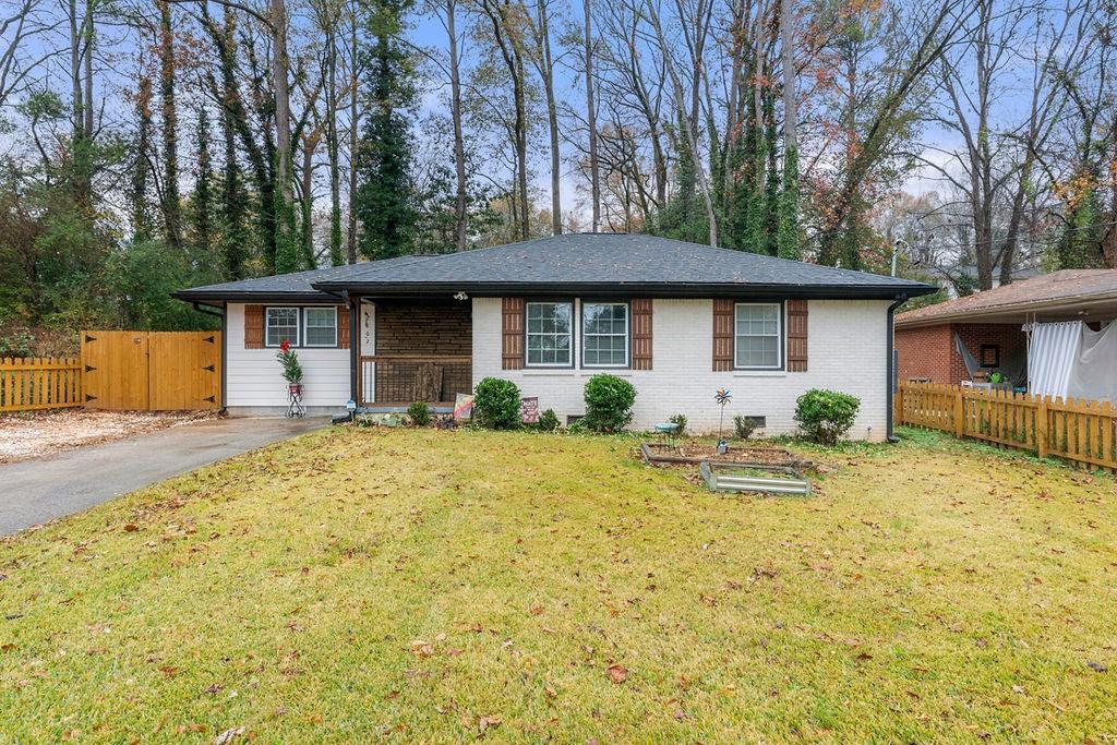 2862 Monterey Drive Decatur, GA 30032 - Photo 1 of 1 a backyard of a house with table and chairs under an umbrella