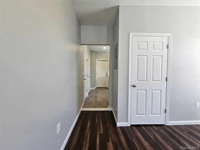 a view of a room with wooden floor and entryway