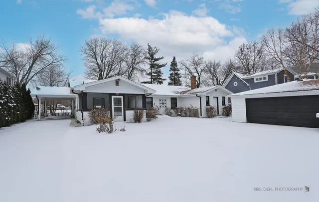 a front view of a house with yard and garage