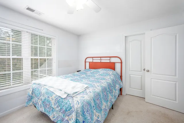 a bedroom with a bed and window