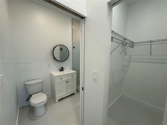 a bathroom with a toilet a sink and shower