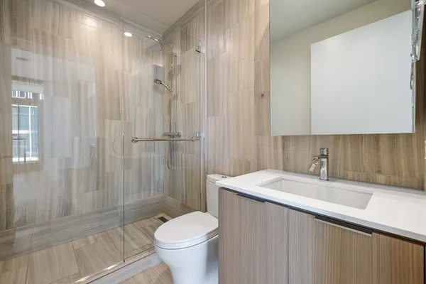 an empty room with wooden floor and ocean view