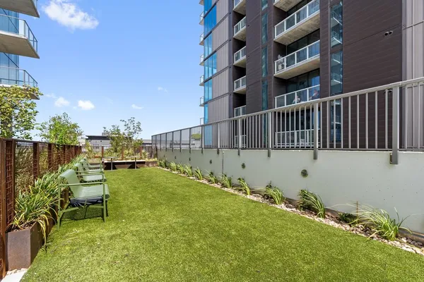 a view of a patio with couches table and chairs and potted plants
