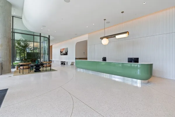 a view of a livingroom with furniture and floor to ceiling window