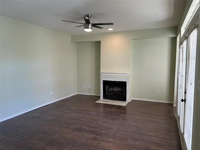 an empty room with a fireplace and window