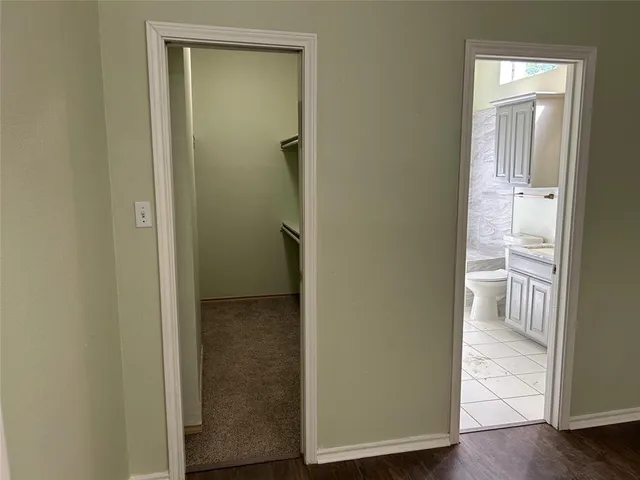 a view of a bathroom with wooden floor