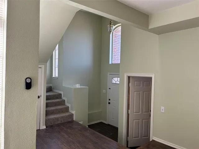 a view of entryway with stairs and wooden floor