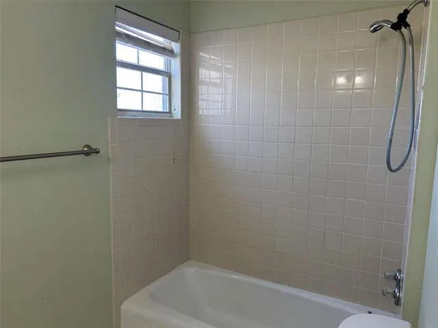 a bathroom with a shower and a bathtub