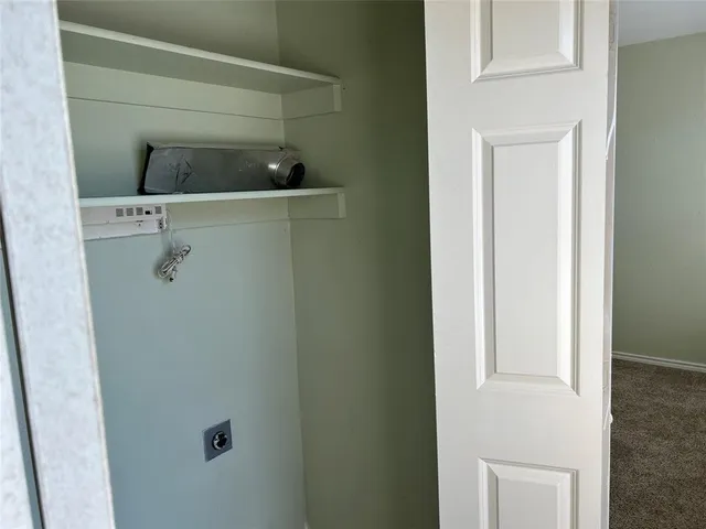 a close view of a utility room with washer dryer