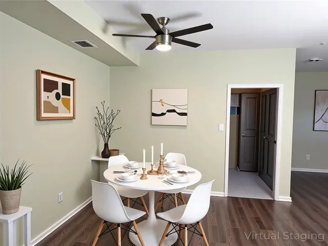 a view of a dining room with furniture and wooden floor