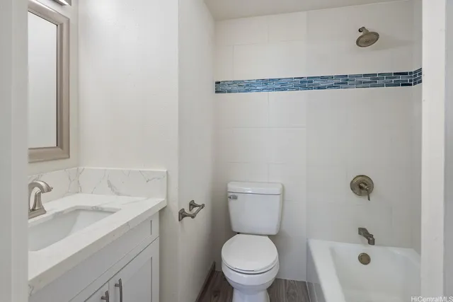 a white toilet sitting next to a bathroom sink