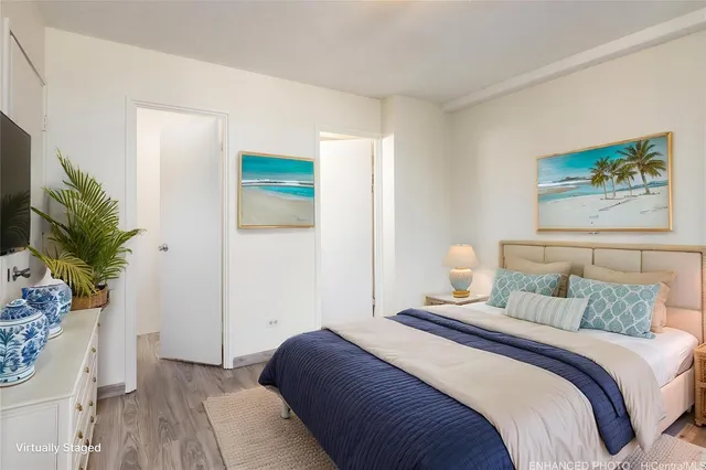 a bedroom with a bed and a potted plant