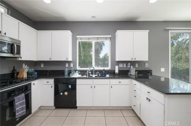 a kitchen with a sink stove top oven and cabinets