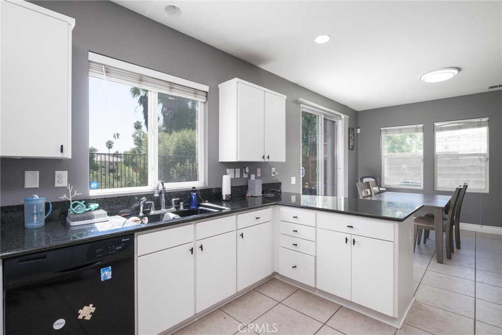 7940 Shadow Trails Lane Jurupa Valley, CA 92509 - Photo 12 of 34 a kitchen with a sink and cabinets