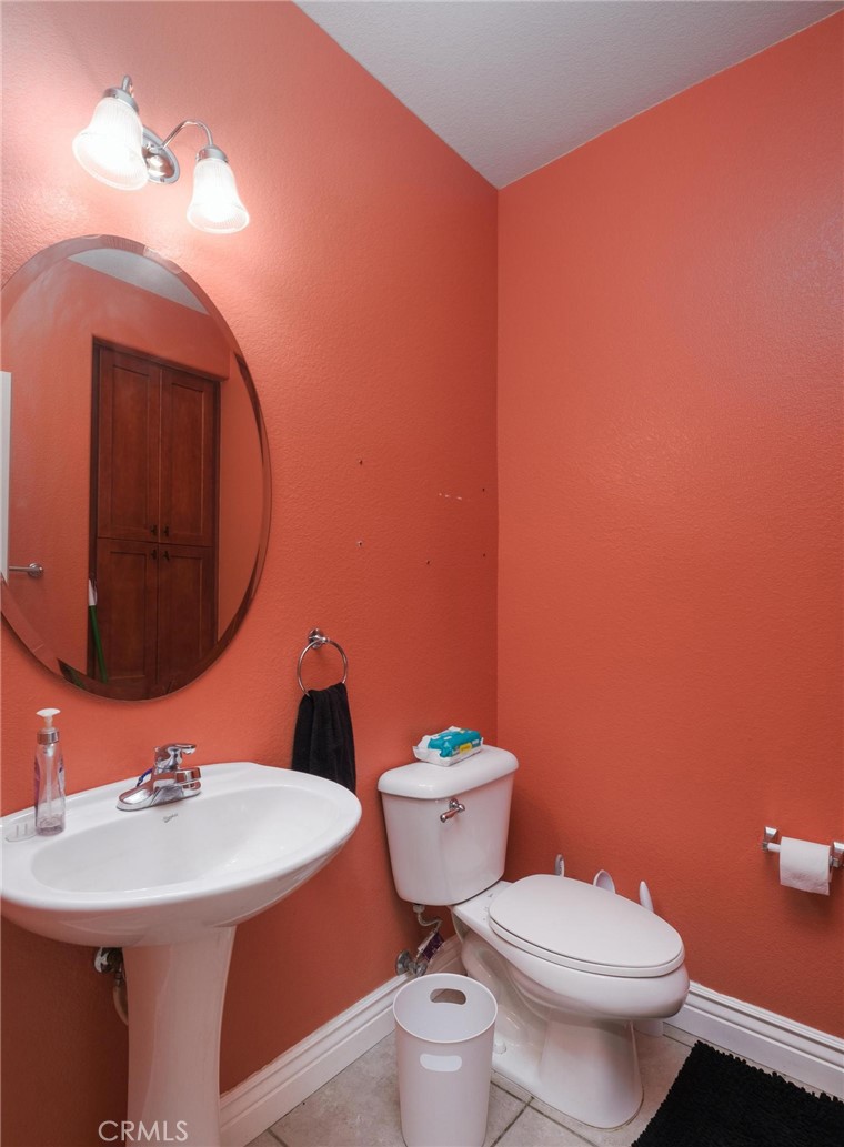 7940 Shadow Trails Lane Jurupa Valley, CA 92509 - Photo 13 of 34 a bathroom with a sink a toilet and mirror