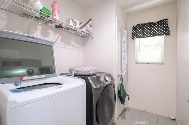 an empty room with windows and ceiling fan