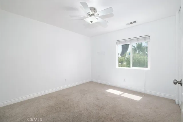 an empty room with a ceiling fan