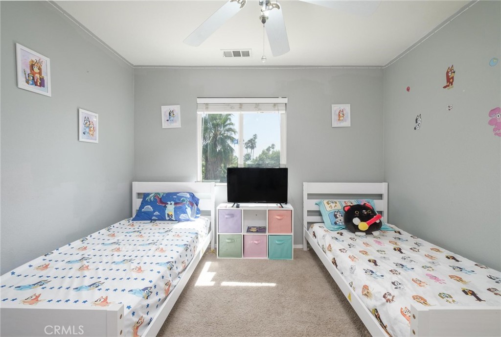 7940 Shadow Trails Lane Jurupa Valley, CA 92509 - Photo 19 of 34 a bedroom with a bed and window