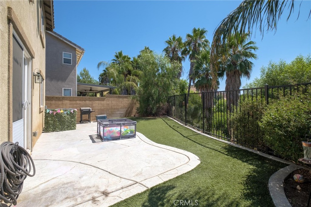 7940 Shadow Trails Lane Jurupa Valley, CA 92509 - Photo 26 of 34 a view of a swimming pool with a patio and garden