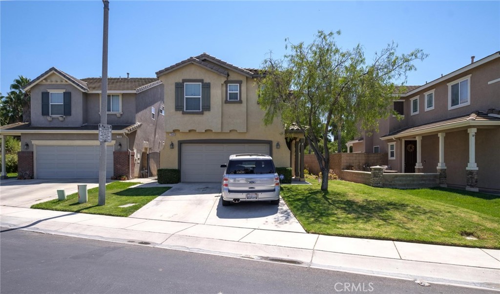 7940 Shadow Trails Lane Jurupa Valley, CA 92509 - Photo 34 of 34 a front view of a house with a garden and trees