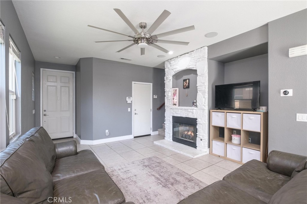 7940 Shadow Trails Lane Jurupa Valley, CA 92509 - Photo 6 of 34 a living room with fireplace furniture and a flat screen tv