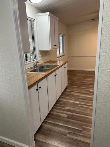 a bathroom with sink shower and mirror