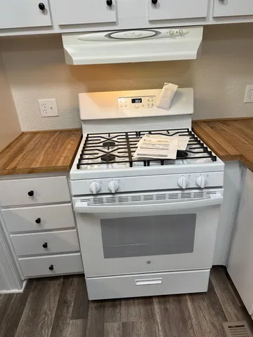 a stove top oven sitting inside of a kitchen