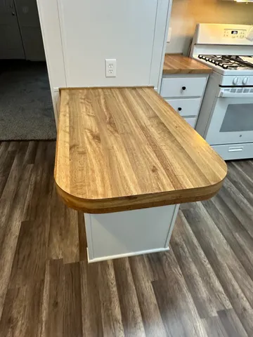 a view of a room with wooden floor and cabinet