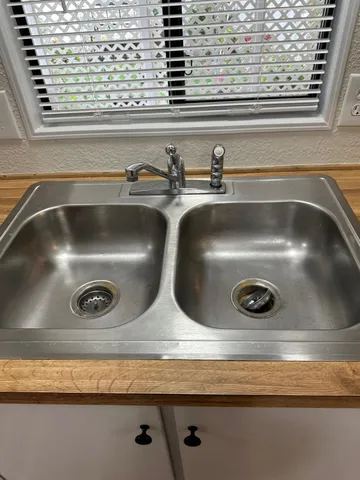 a bathroom with a sink a toilet a shower and a mirror