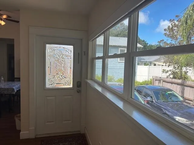 a room with a large window and a bed