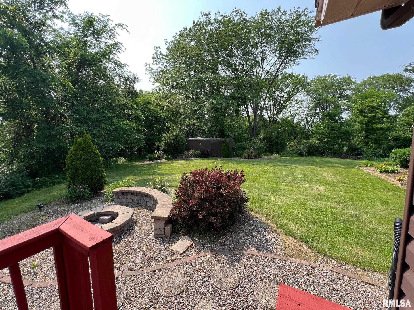 108 Andrea Court Cleveland, IL 61241 - Photo 11 of 32 a backyard of a house with table and chairs