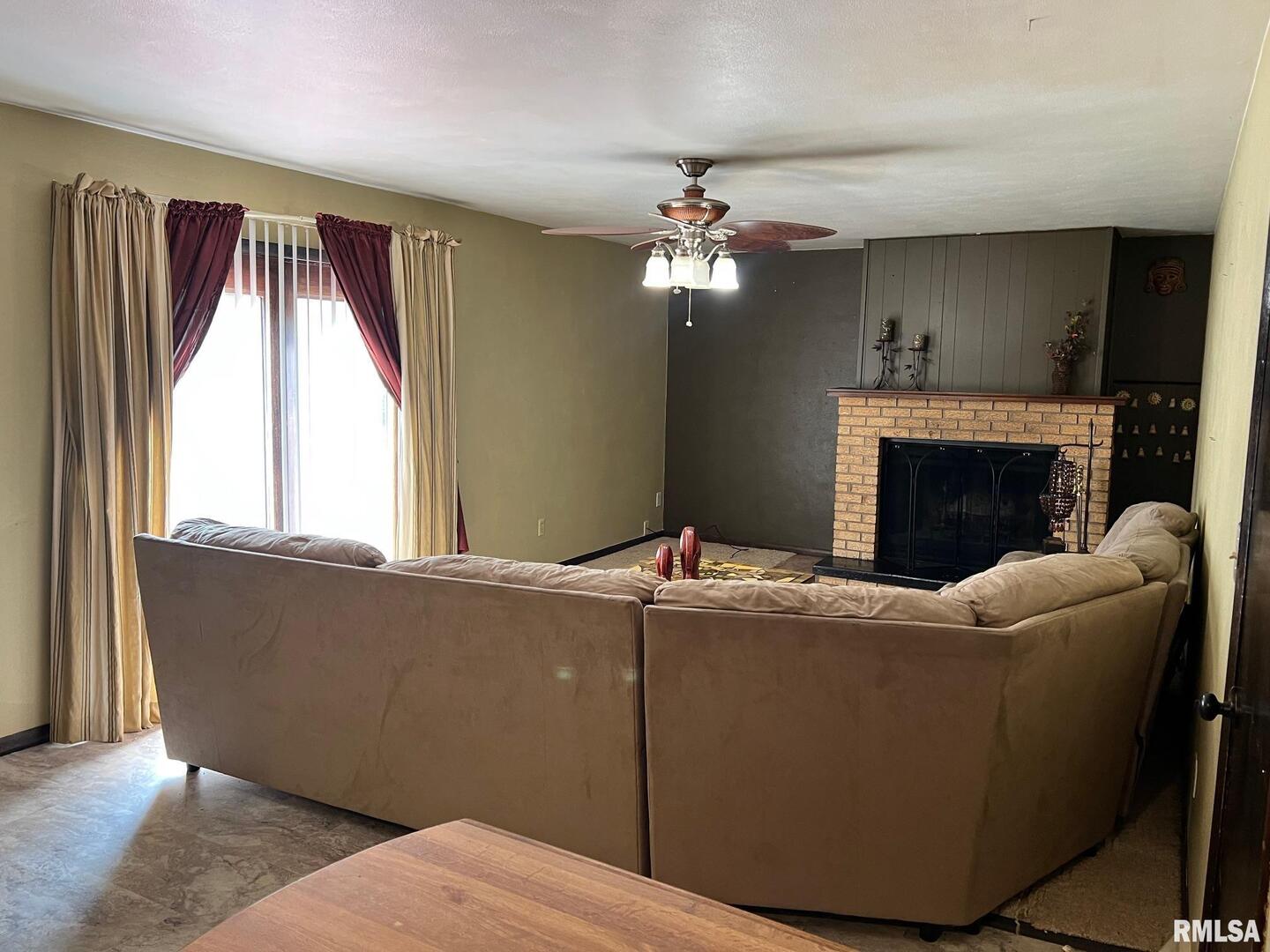 108 Andrea Court Cleveland, IL 61241 - Photo 13 of 32 a living room with furniture and a fireplace