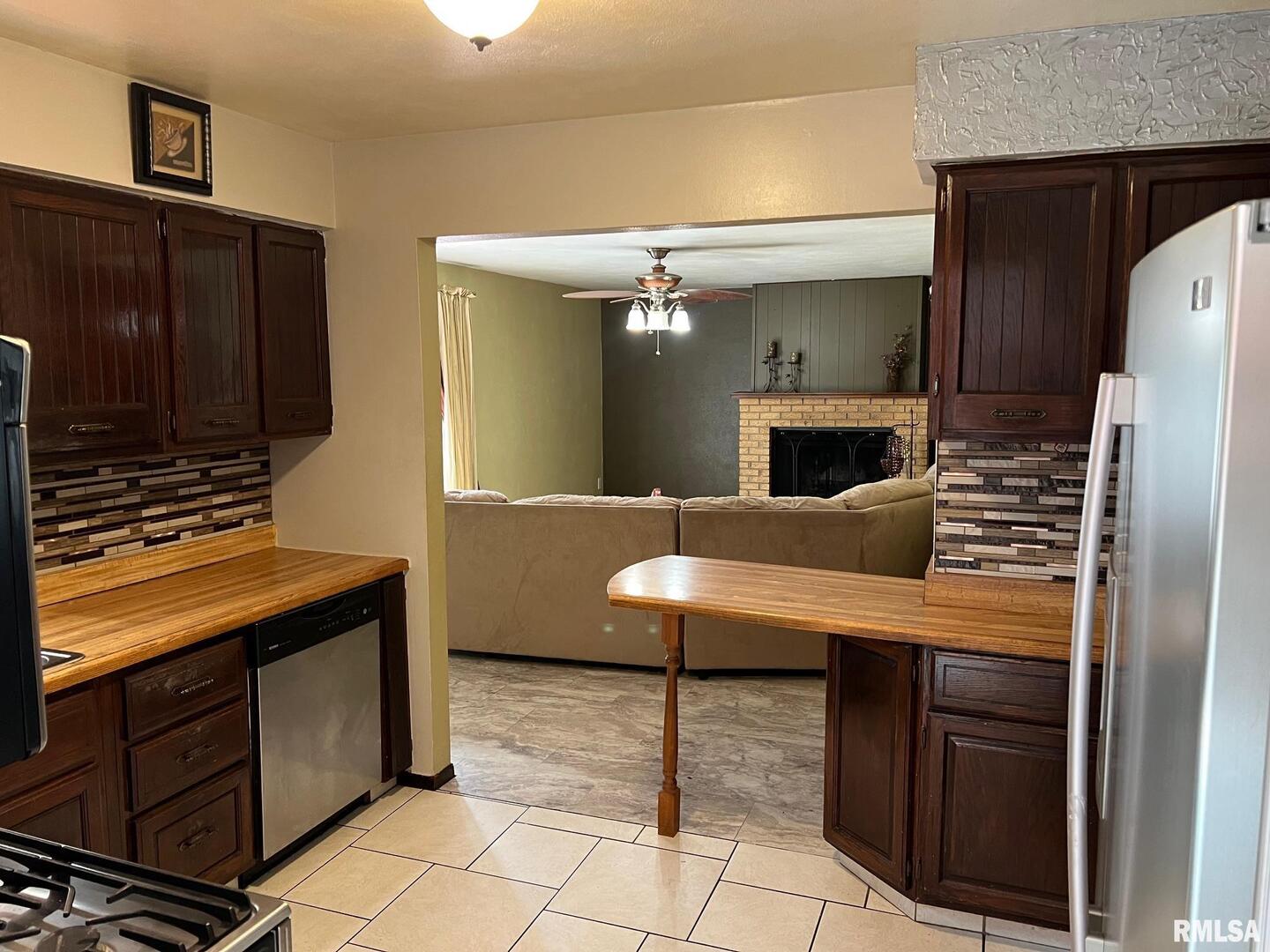 108 Andrea Court Cleveland, IL 61241 - Photo 16 of 32 a kitchen with stainless steel appliances kitchen island granite countertop a refrigerator and a stove top oven