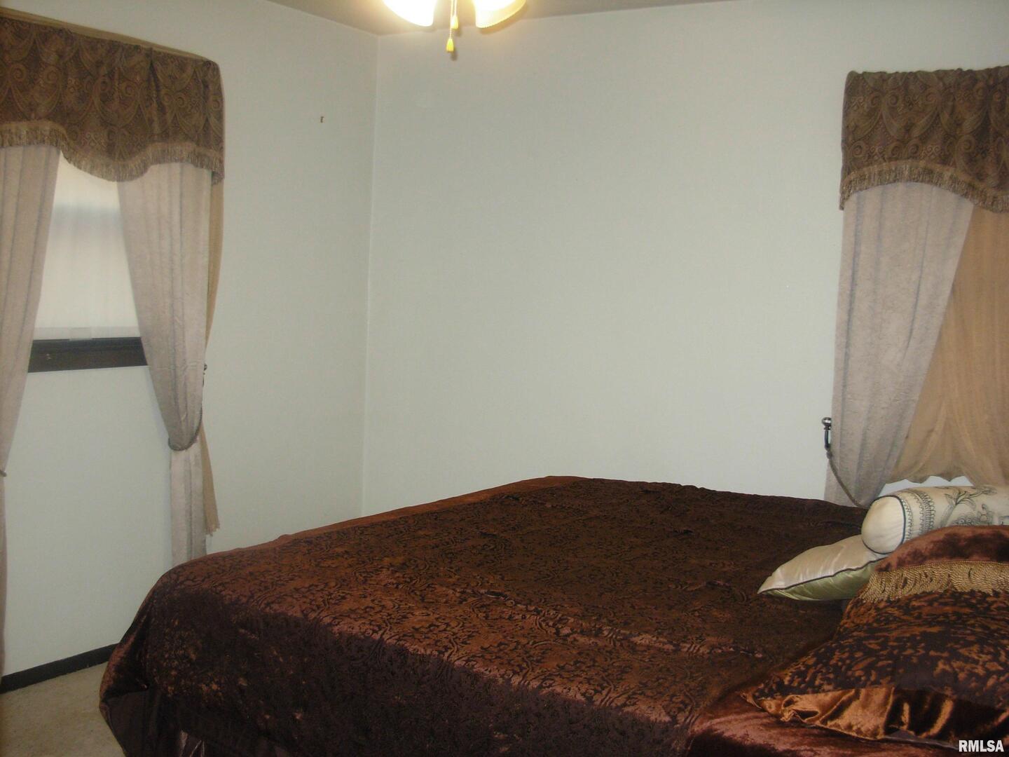 108 Andrea Court Cleveland, IL 61241 - Photo 23 of 32 a bedroom with a bed and a chandelier