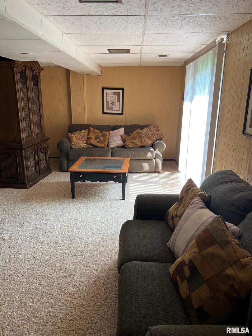 108 Andrea Court Cleveland, IL 61241 - Photo 30 of 32 a living room with furniture and a flat screen tv