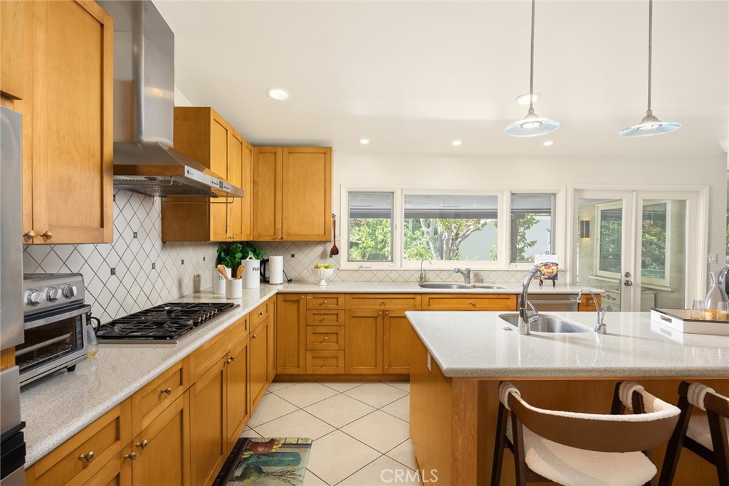 1439 Wembley Road San Marino, CA 91108 - Photo 13 of 45 a kitchen with stainless steel appliances granite countertop a sink a stove and a wooden cabinets