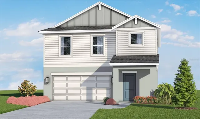 a front view of a house with a yard and garage