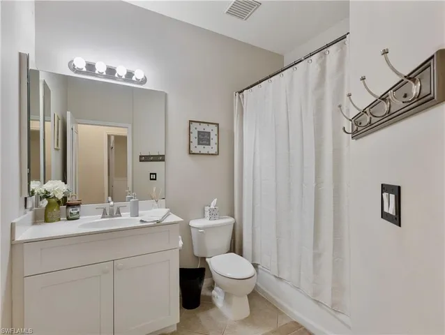 a bathroom with a toilet a sink and a mirror