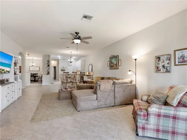 a living room with furniture and white walls