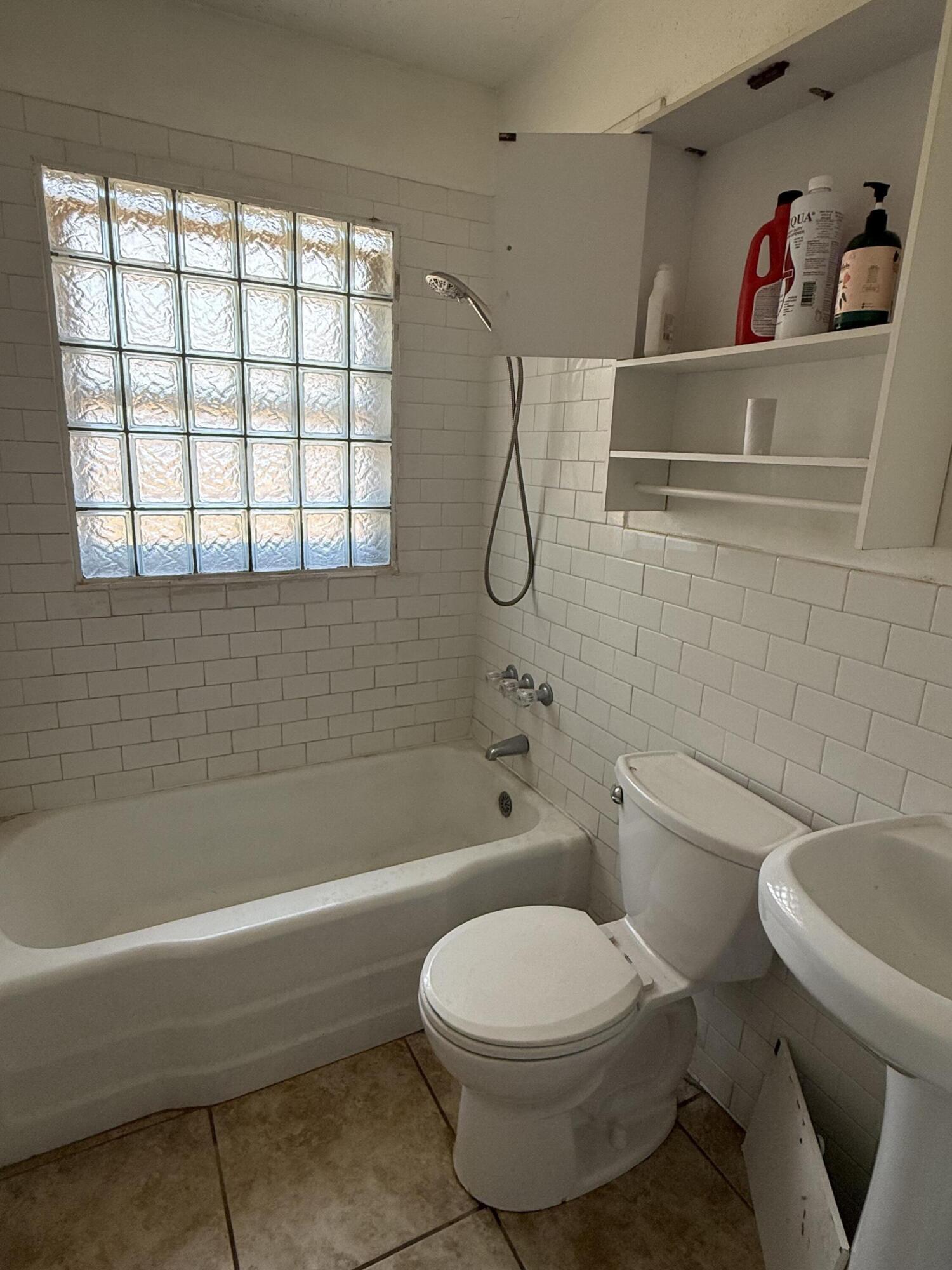 2817 63rd Street Lubbock, TX 79413 - Photo 8 of 16 a bathroom with a toilet and a bath tub
