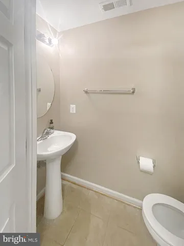 a bathroom with a sink a toilet and mirror