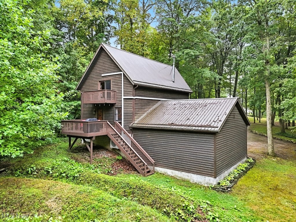 6711 Booth Road Ravenna, OH 44266 - Photo 43 of 50 Rear view of property with a metal roof, stairway, a deck, and view of wooded area