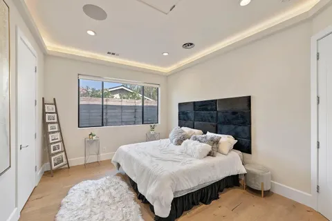 a spacious bedroom with a bed and a window
