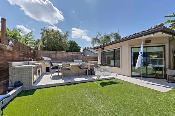 a view of a house with swimming pool and sitting area