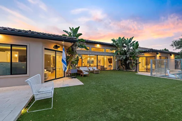 a view of a house with backyard porch and sitting area